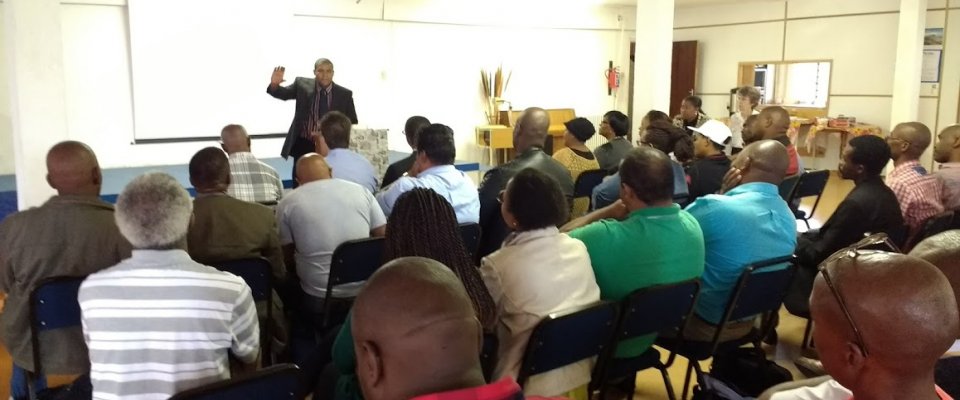 Rev. Arthur Alard (Principal) speaking in chapel